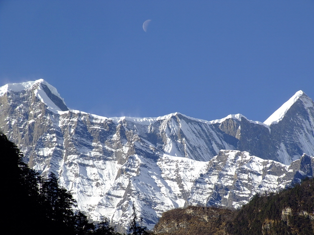 Daylight Moon over Annapurna mountains in Nepal